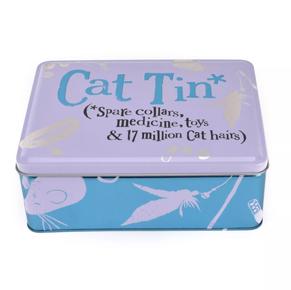 A square metal tin with a white lid printed with the words 'Cat Tin' in blue and black text, plus decorative gold and blue illustrations. The lower portion of the tin is light blue with white cat-themed graphics.