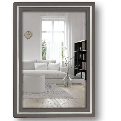 Framed mirror showing a living room with a sofa and decor.