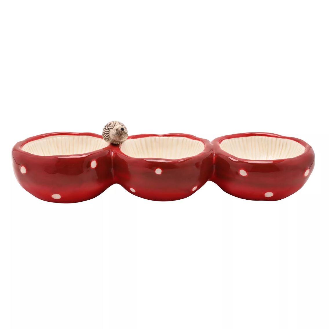 A three-compartment ceramic bowl set in glossy red with white polka dots and cream-colored interiors, featuring a small hedgehog figurine on the left divider, shown against a plain white background.