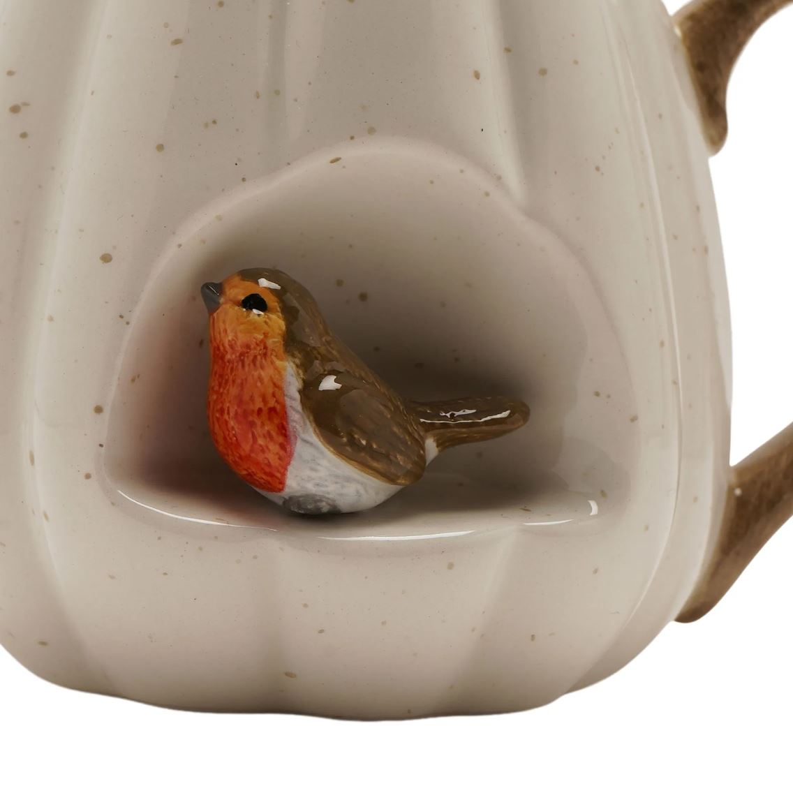Close-up of a ceramic mug handle and body featuring a sculpted robin bird sitting in a recessed area. The mug has a speckled off-white glaze with brown speckles, and the robin has a bright red-orange breast, brown wings, and a white belly.
