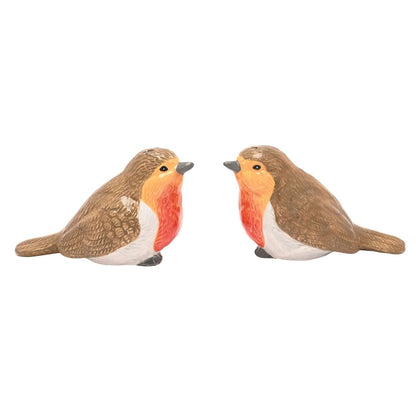 Two small robin bird figurines facing each other on a plain white background.