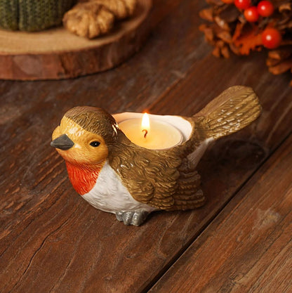 Bird-shaped candle holder with a lit candle on a wooden surface