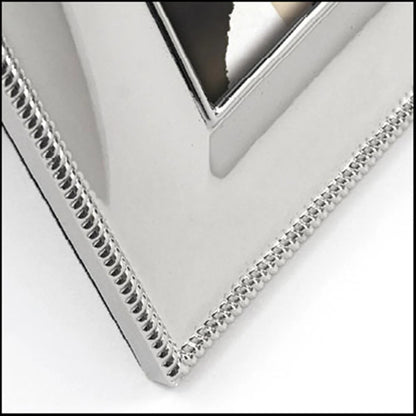 Close-up of a silver photo frame corner with a white background