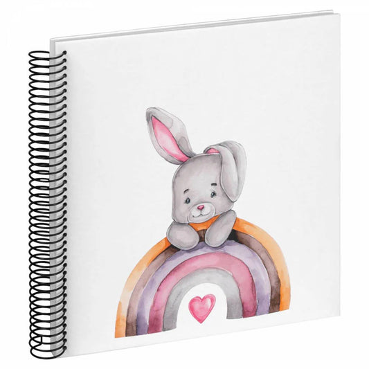 Notebook with a cute illustration of a bunny on a rainbow, featuring a heart at the end, on a white background.