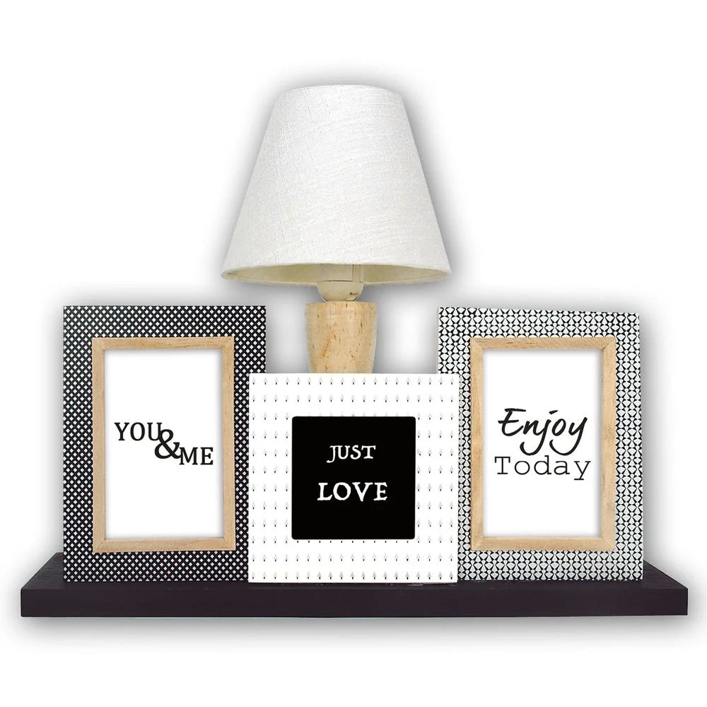 Decorative shelf with framed quotes and a lamp on a white background