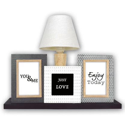 Decorative shelf with framed quotes and a lamp on a white background