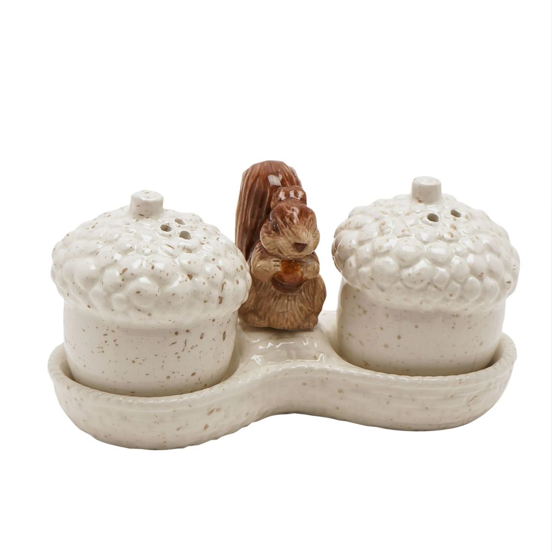 A ceramic acorn-shaped salt and pepper shaker set with a small brown squirrel figurine in the center, on a white background.