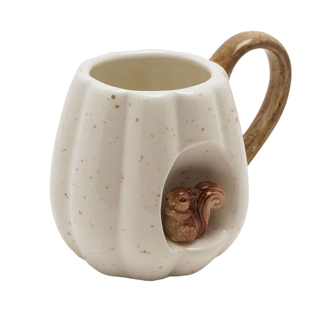 A ceramic pumpkin-shaped mug with a speckled cream glaze, a brown wooden handle, and a carved squirrel figure nestled inside a front-facing pumpkin opening.