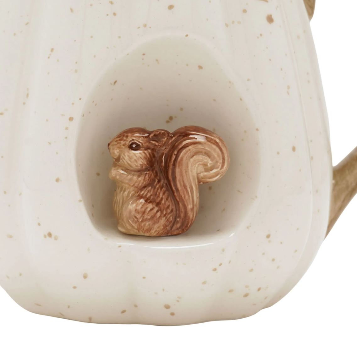 Close-up of a ceramic Mug with a speckled off-white glaze, featuring a small sculpted brown squirrel figure placed inside the centre.