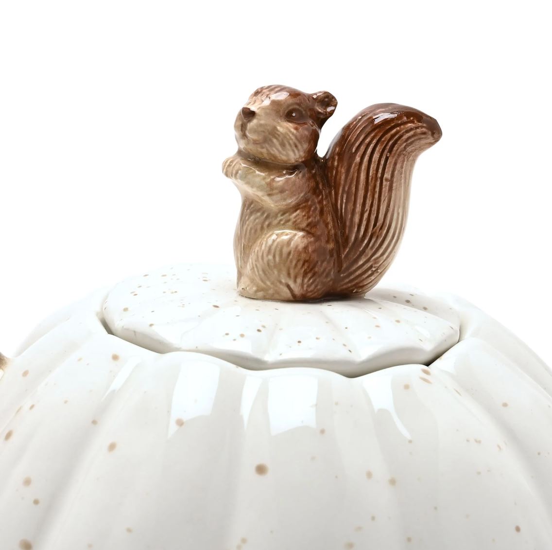A close-up of a ceramic jar lid featuring a small brown glazed squirrel figurine perched on top of a white speckled ceramic body.