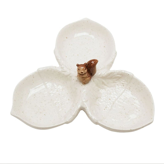 A three-petal ceramic dish with a small brown squirrel figurine in the center, set against a plain white background.