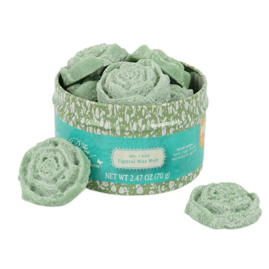 Green wax melts in a decorative container on a white background