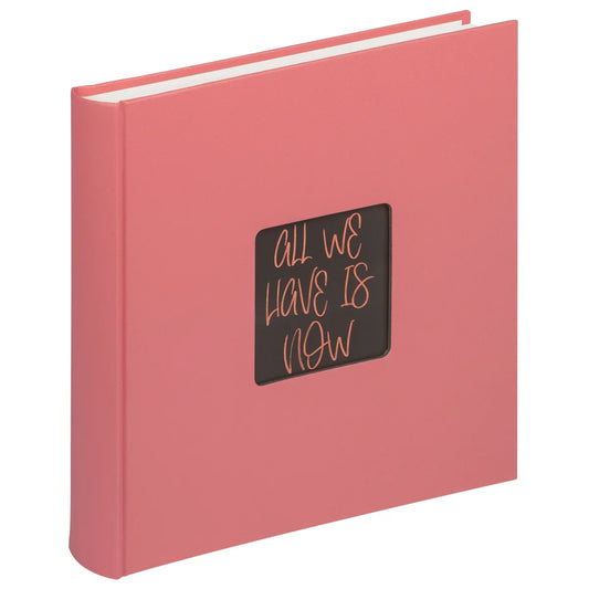 Pink book with a black square on the cover featuring text, on a white background