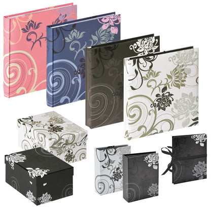 A set of floral-patterned albums and matching gift boxes shown on a plain white background. The covers come in pink, blue, dark brown, white, black, and grey, each with a different floral and scroll design.