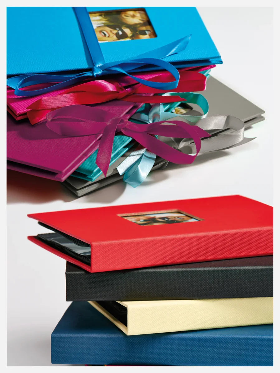 Colorful photo albums with ribbons on a white background