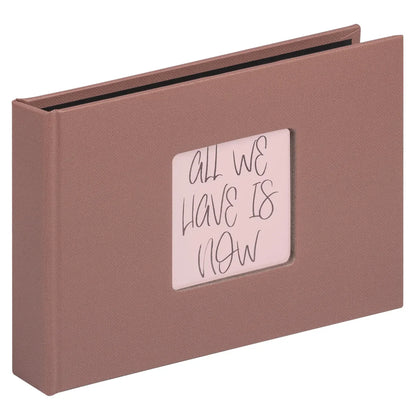 Brown photo album with a small window displaying 'All We Have Is Now' text on a white background