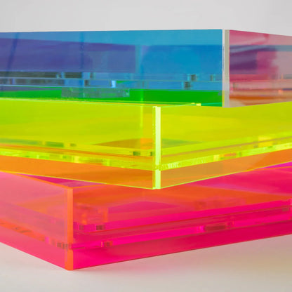 Stacked translucent acrylic frames in a rainbow colour sequence, including blue, green, yellow, orange, and pink, on a light grey background.